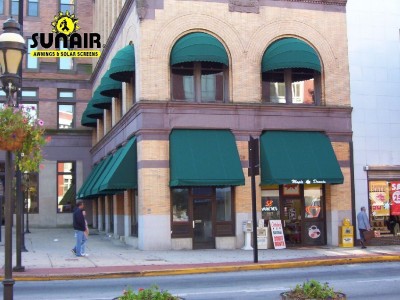 Green awnings over windows of plaza